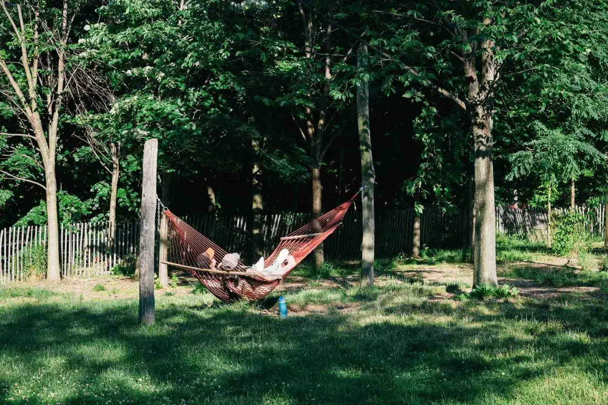 Two people lay down on hammocks in Hammock Grove 