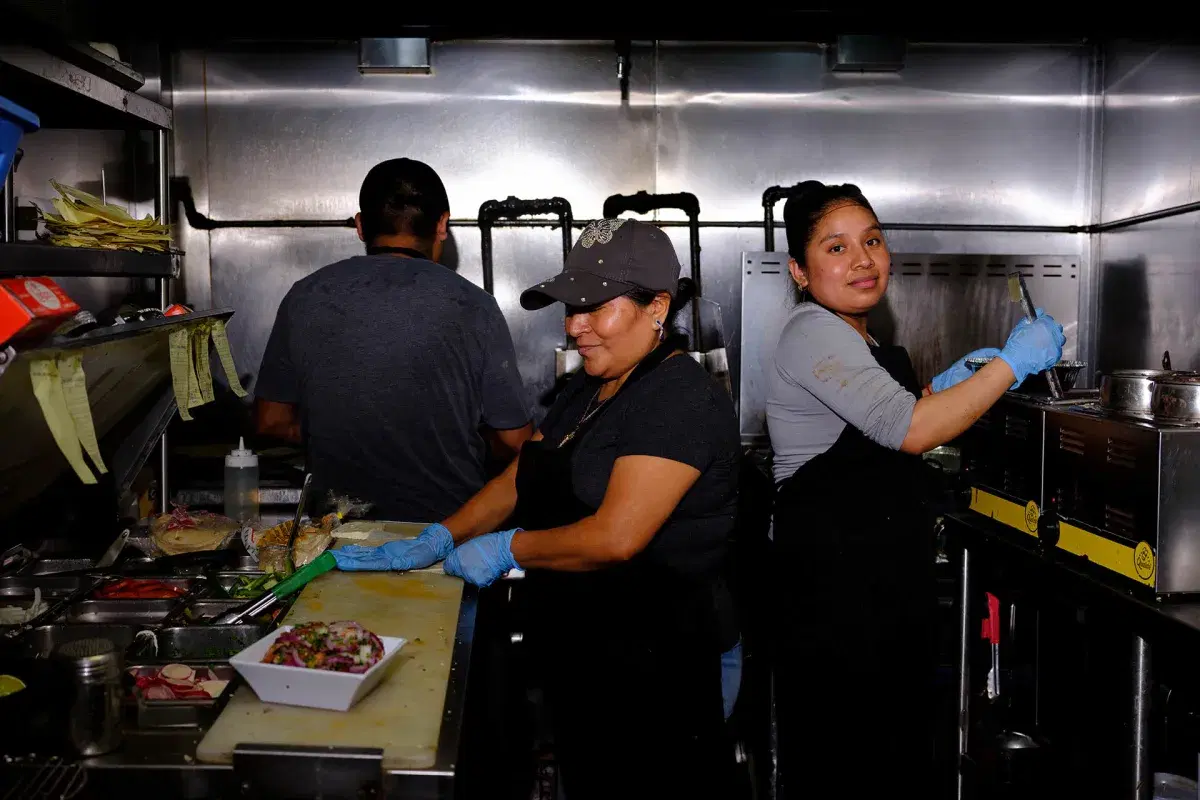 Three people cook in Xochimilco's kitchen 