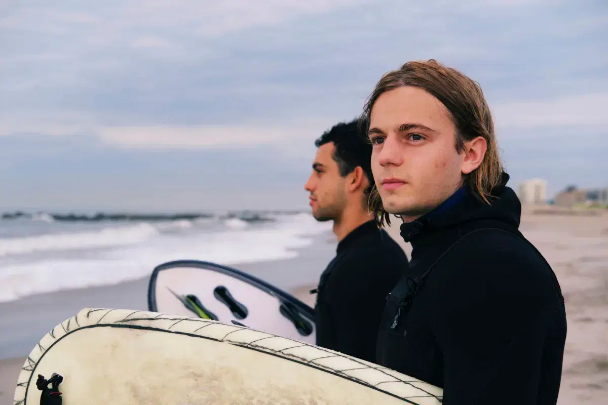 Surfers holding surfboards in Rockaway Beach