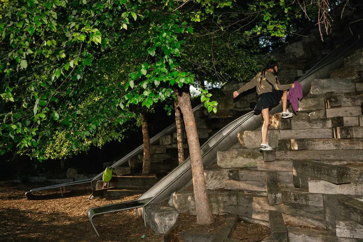 A kid climbs over rocks at the Slide Down Slide Hill and Climb Outlook Hill