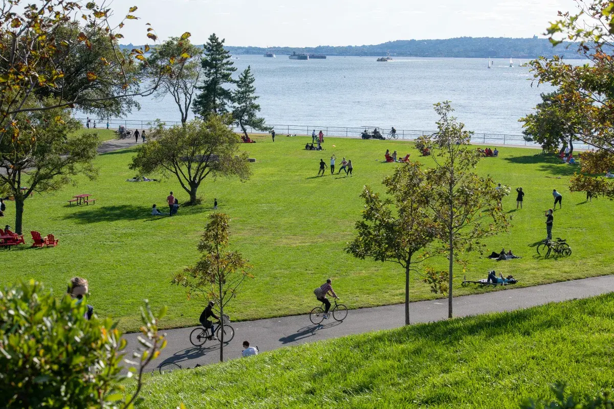 People enjoying a sunny day in picnic point at governors island