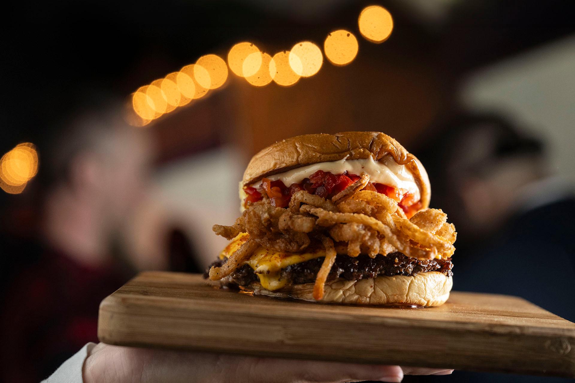 A hand holds a burger plate