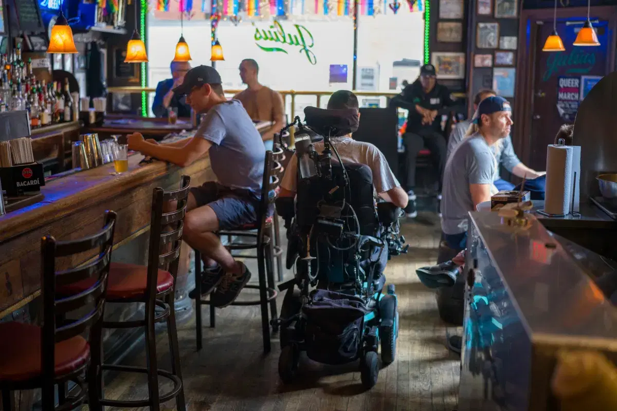 Photographer on wheelchair inside Julius Bar