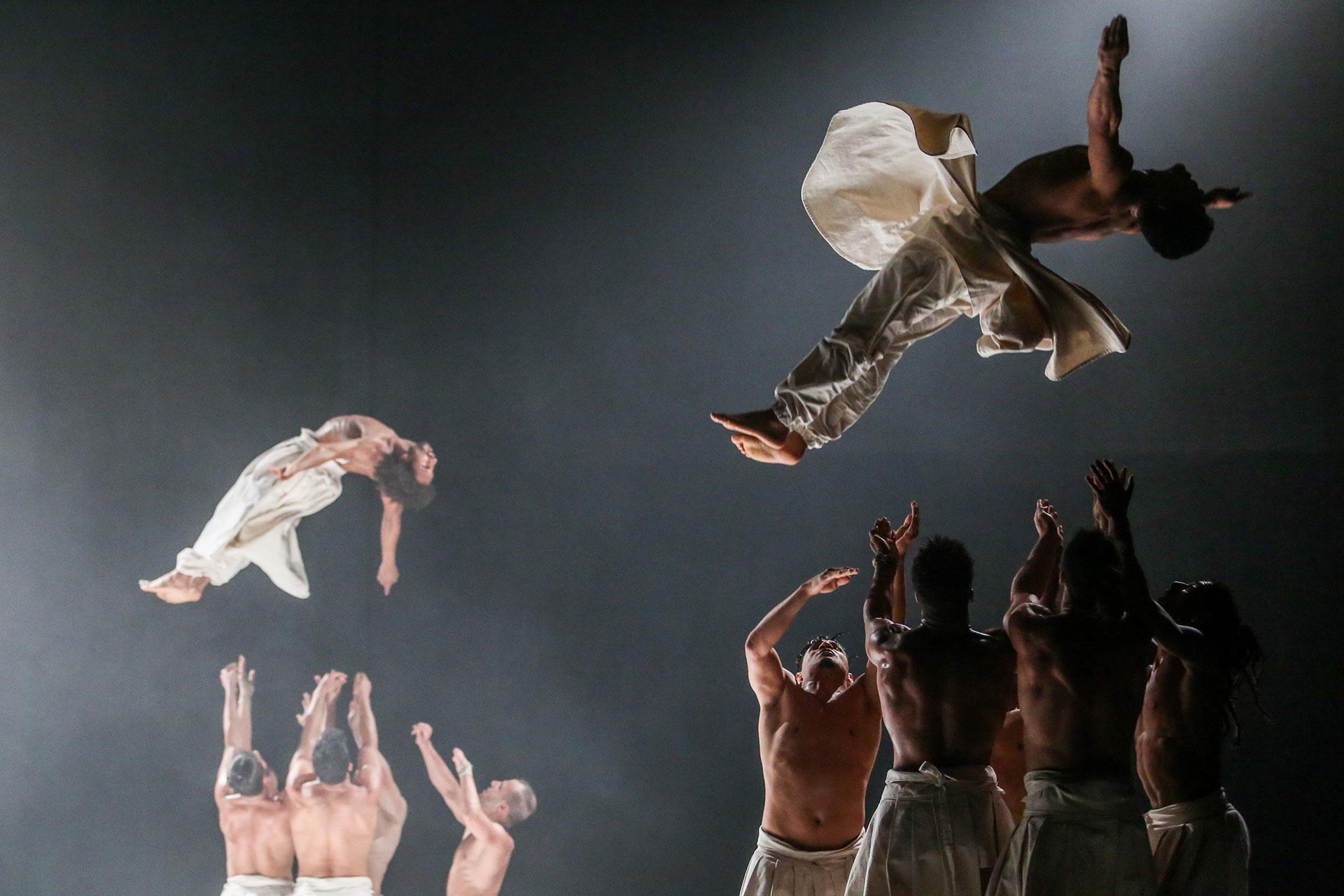 Dancers on stage perform an urban dance mixed with martial arts 