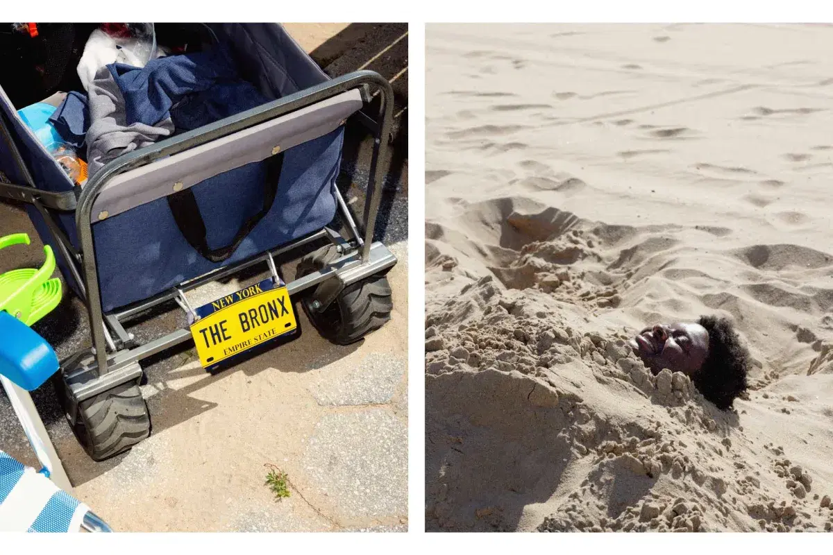 Person buried under sand and beach cart with Bronx plate