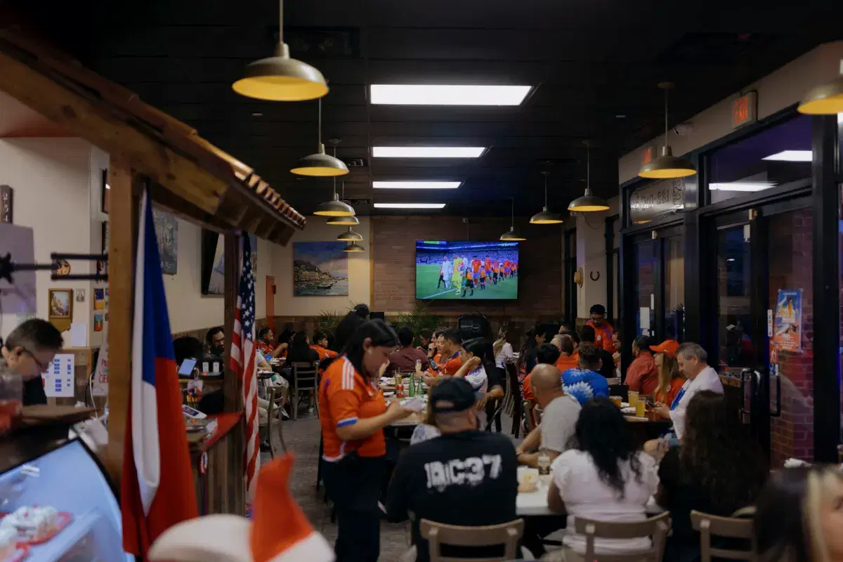 People dine and order food while waiting for the game to begin.