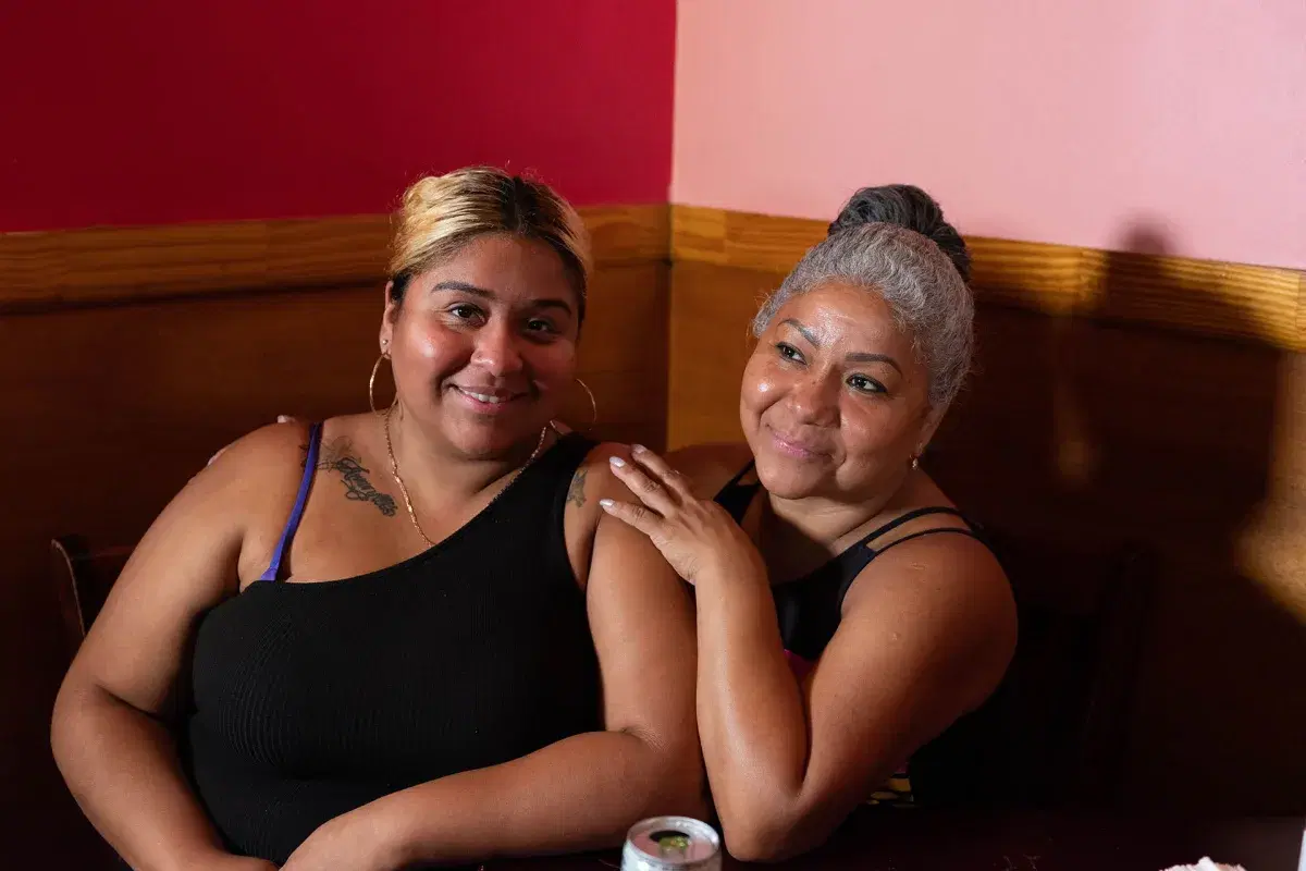 A portrait of two people sitting on a table at Xochimilco