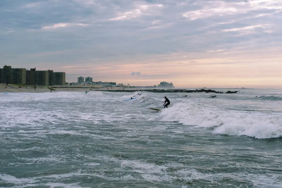 People surf at Rockaway Beach in Queens. 