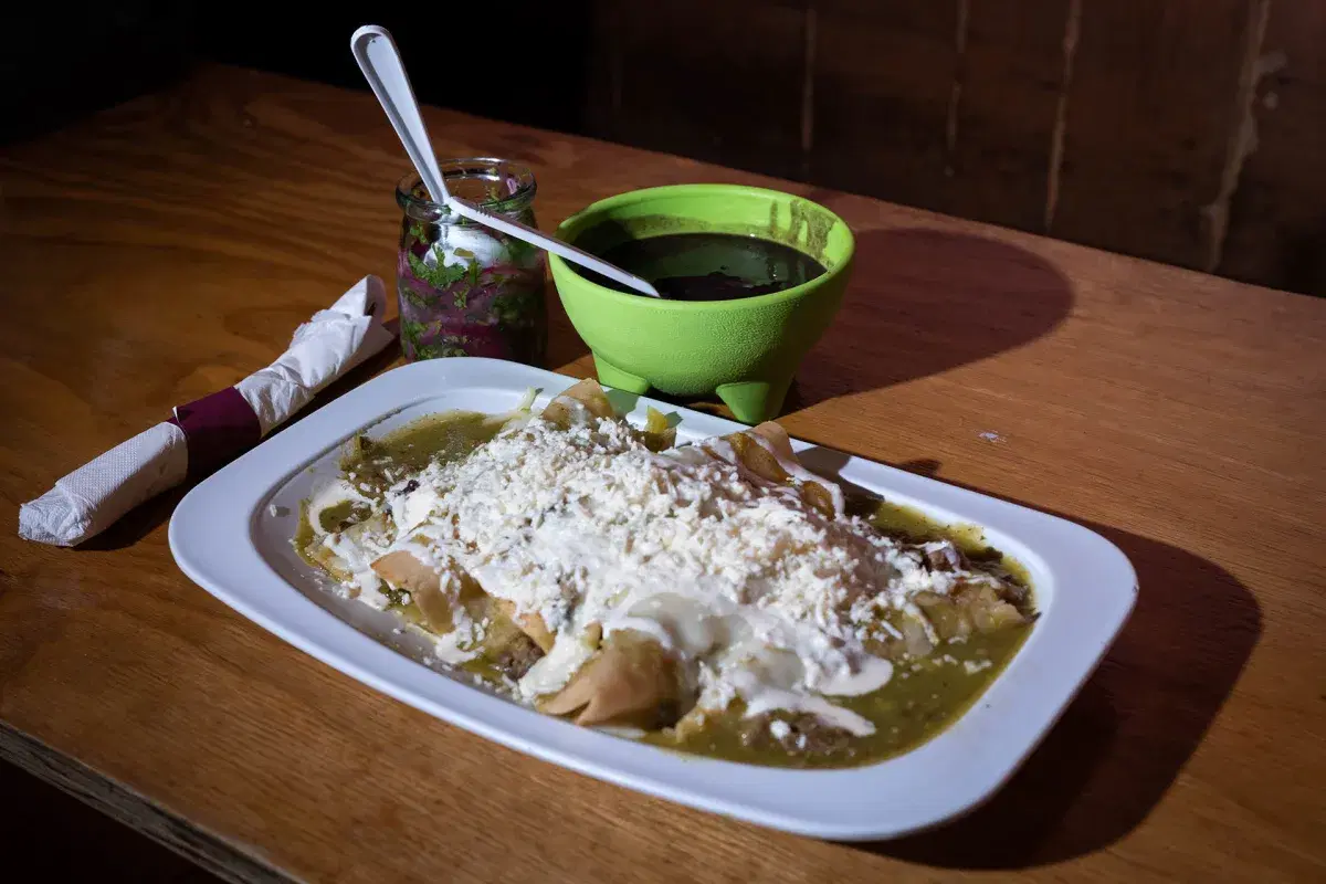 Green Enchiladas with sour cream and cheese on top