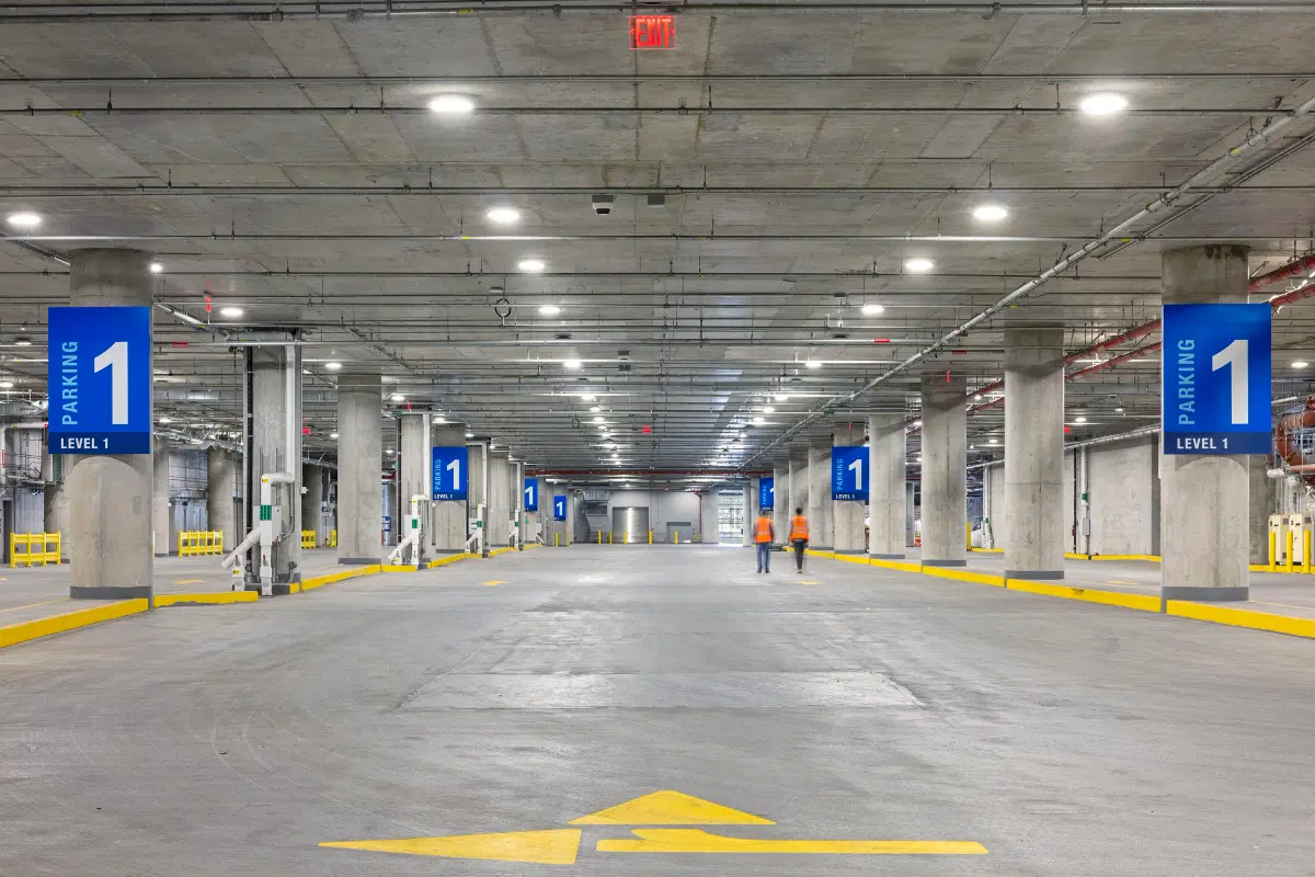 Two people walk at a parking lot 