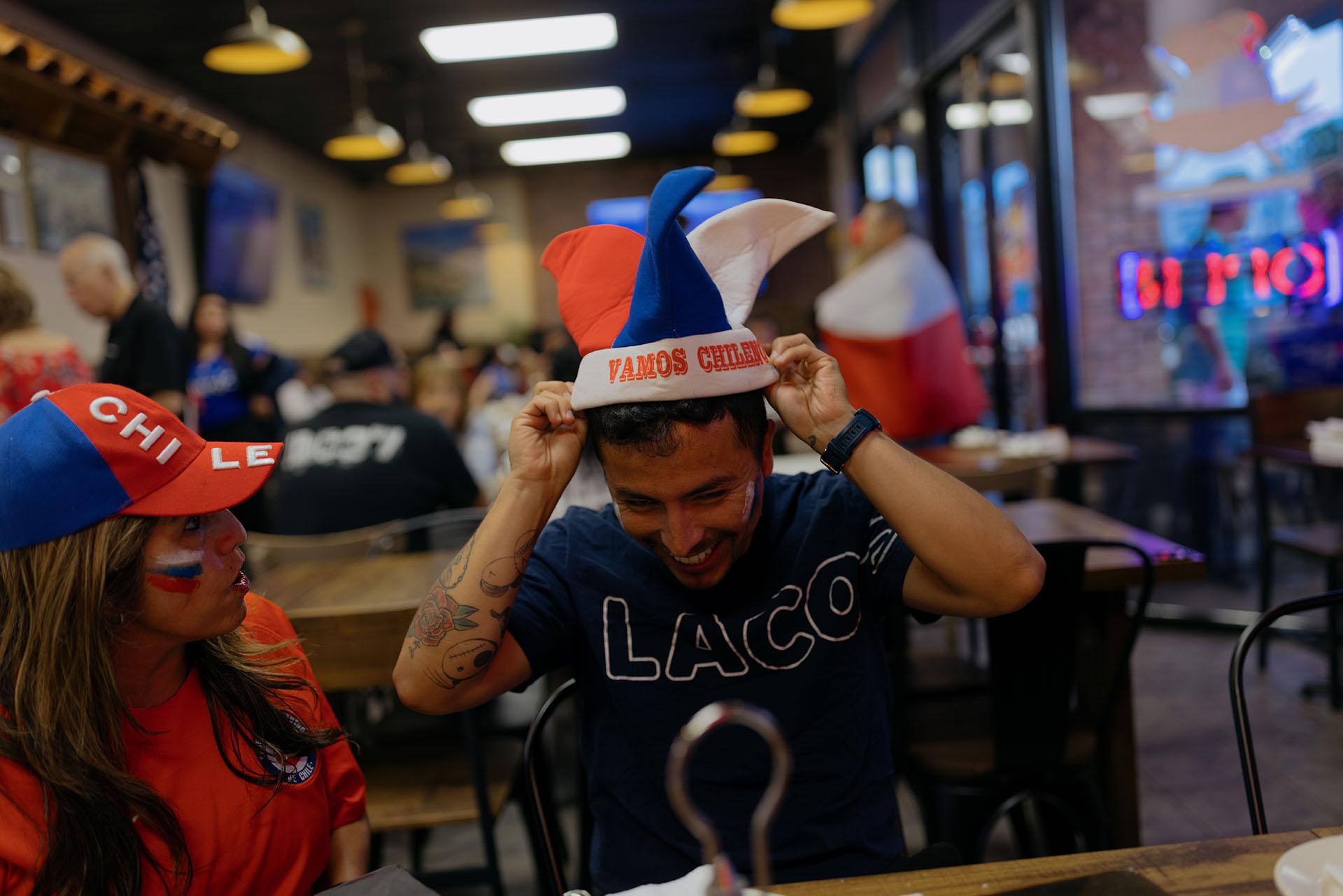 A person wears a Chilean hat while celebrating before the game starts.