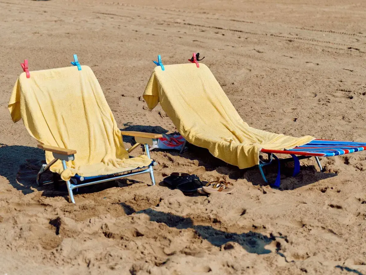 Two empty beach chairs at Brighton Beach in Brooklyn. 