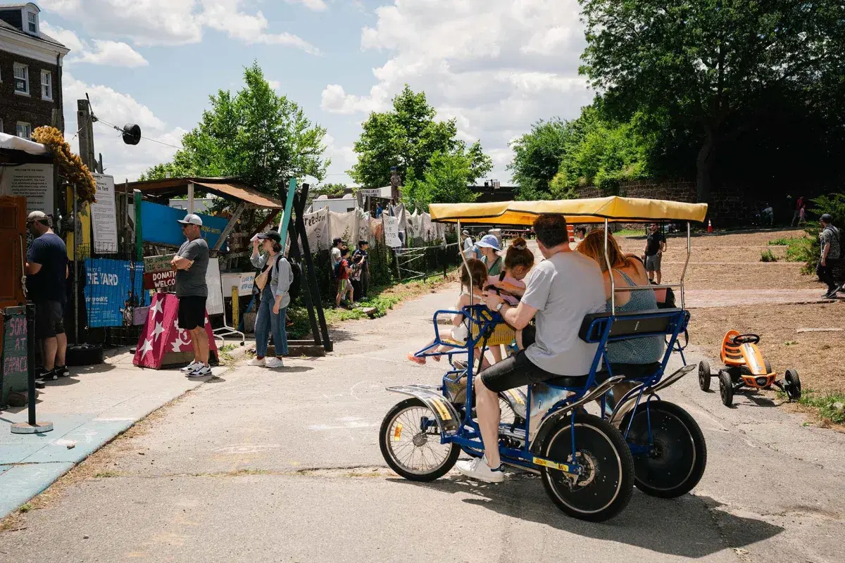 People on a pedal car at Governors Island 