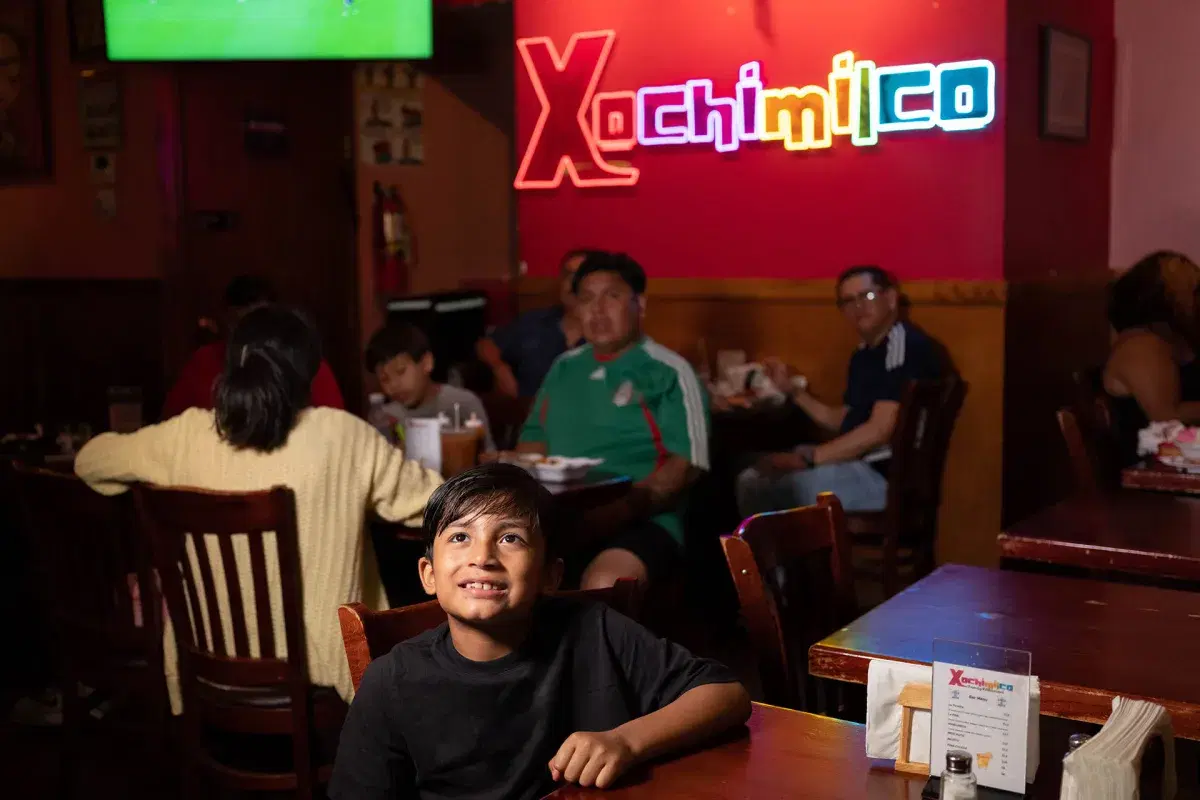 A young person watches the Mexico vs Ecuador game at Xochimilco. 