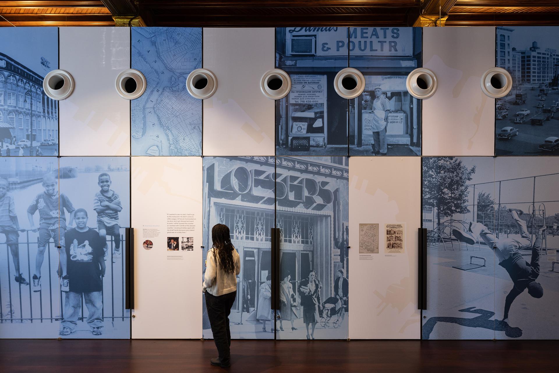 A person looks at photography at the Center for Brooklyn History