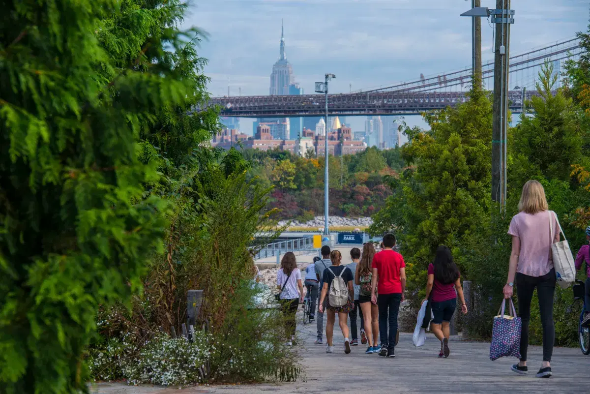 People walking in Brooklyn Bridge Park on a sunny day