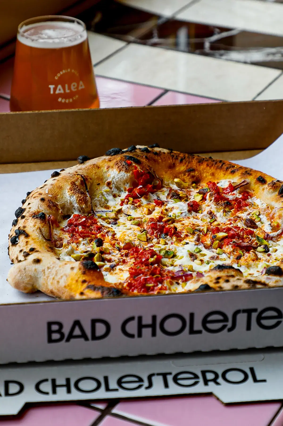 A pizza from Bad Cholesterol and a Talea beer