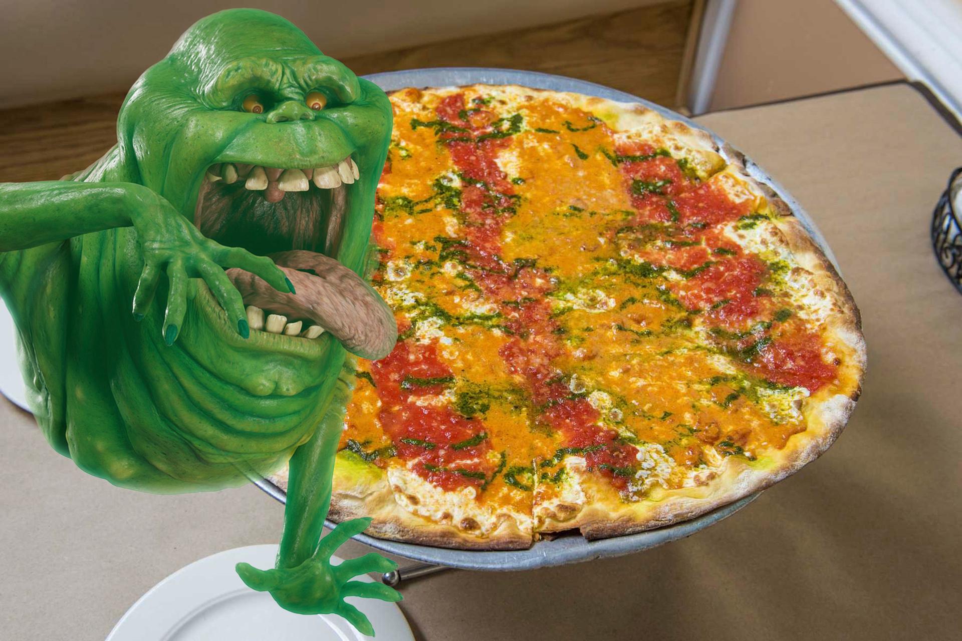 Slimer from Ghostbusters eating pizza at Joe and Pats