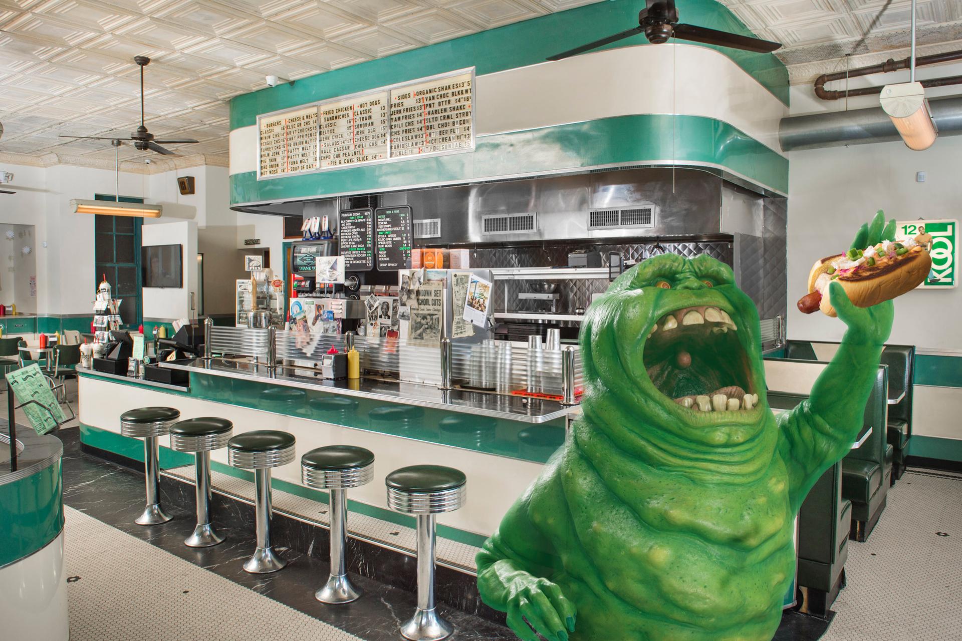Slimer from Ghostbusters eating a hot dog at Harlem Shake