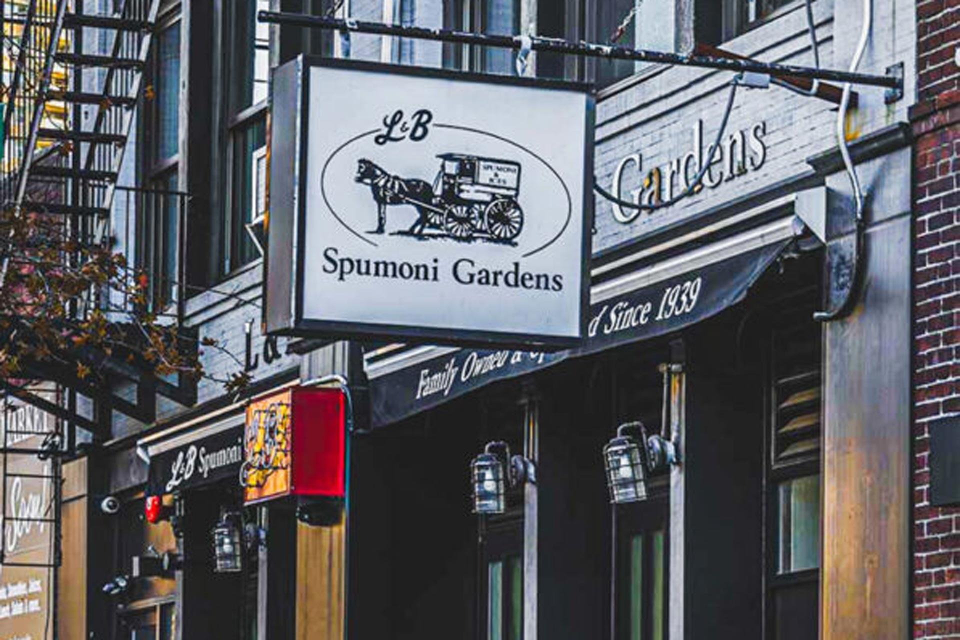 A street view of the L&B Spumoni Gardens storefront, featuring a hanging sign with a horse and cart graphic, and an awning reading "Family Owned and Operated Since 1939.