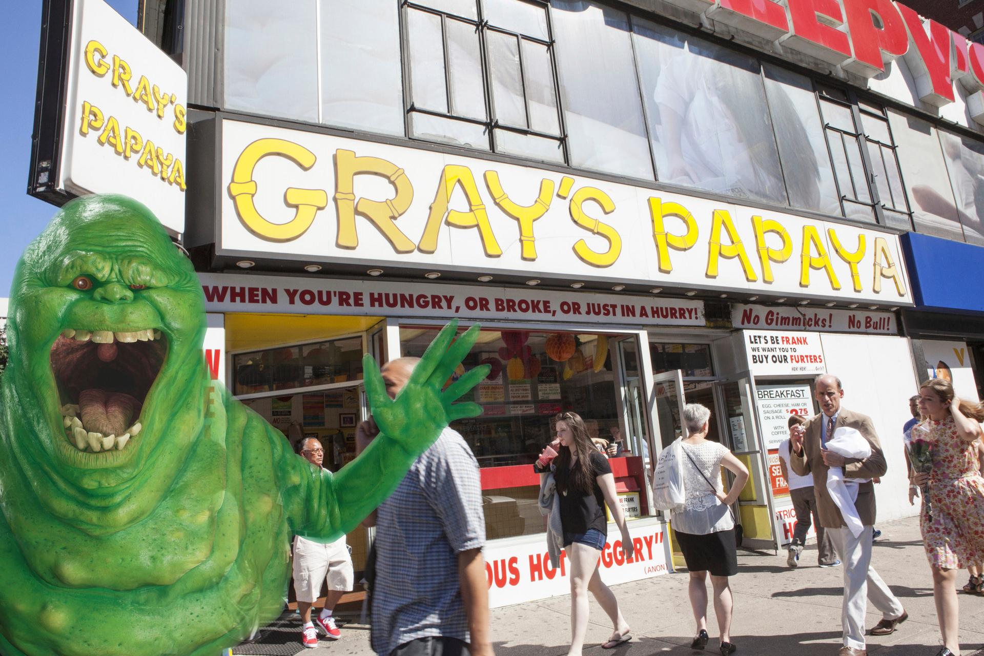 Slimer from Ghostbusters standing in front of Grey's Papaya